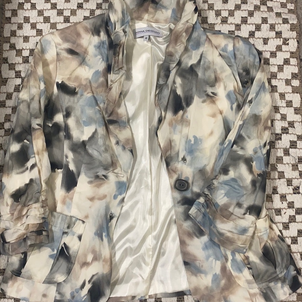 A cream, blue, tan, and grey mixture light weight over coat, silky and durable